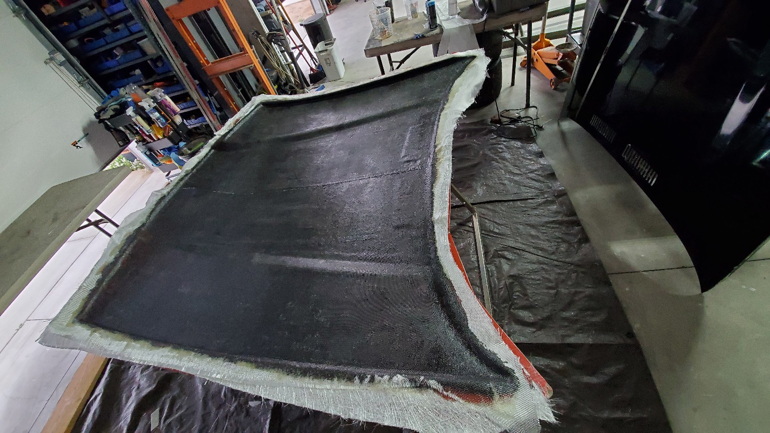 Lightweight fiberglass body panel being fabricated for the E36 BMW
