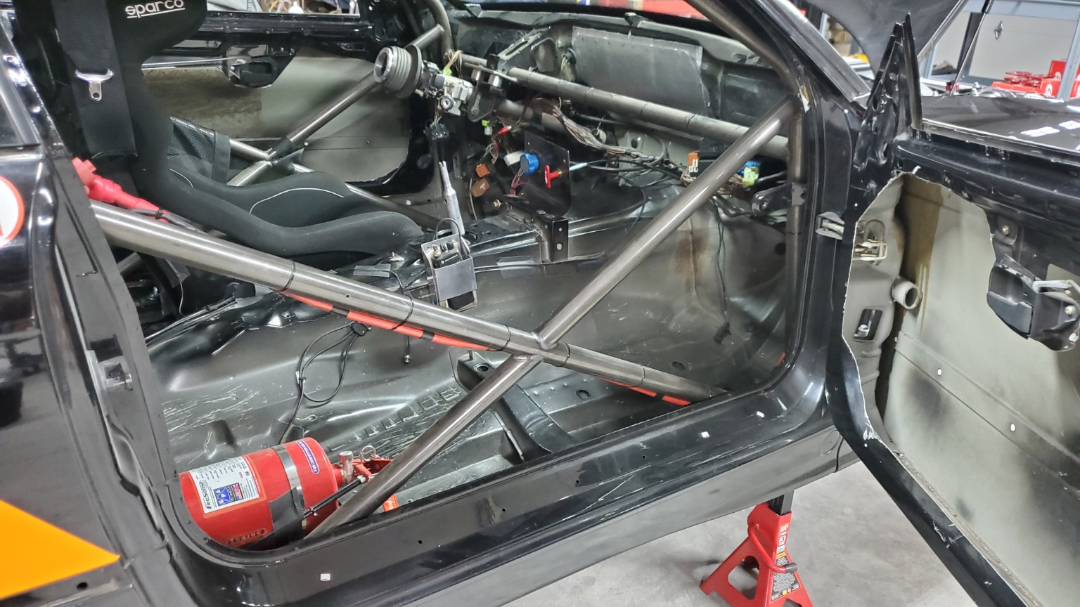 Side view of the E36 BMW roll cage and stripped racing interior