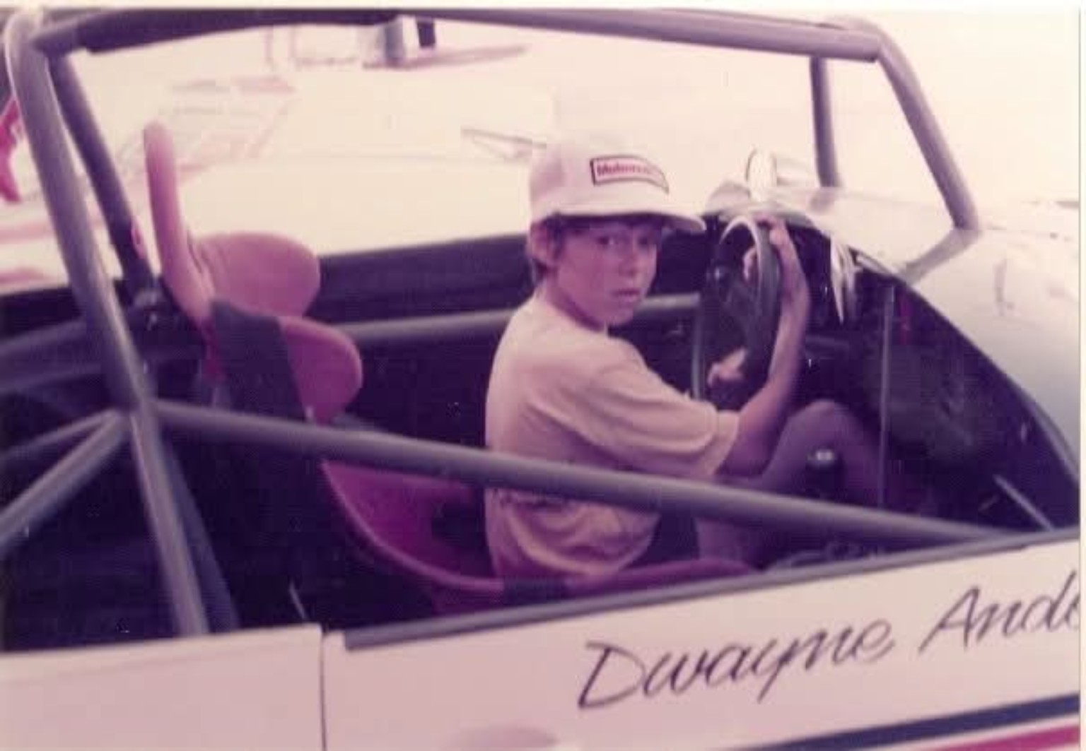 A young Mike Anderson sitting in his father Dwayne Anderson's race car