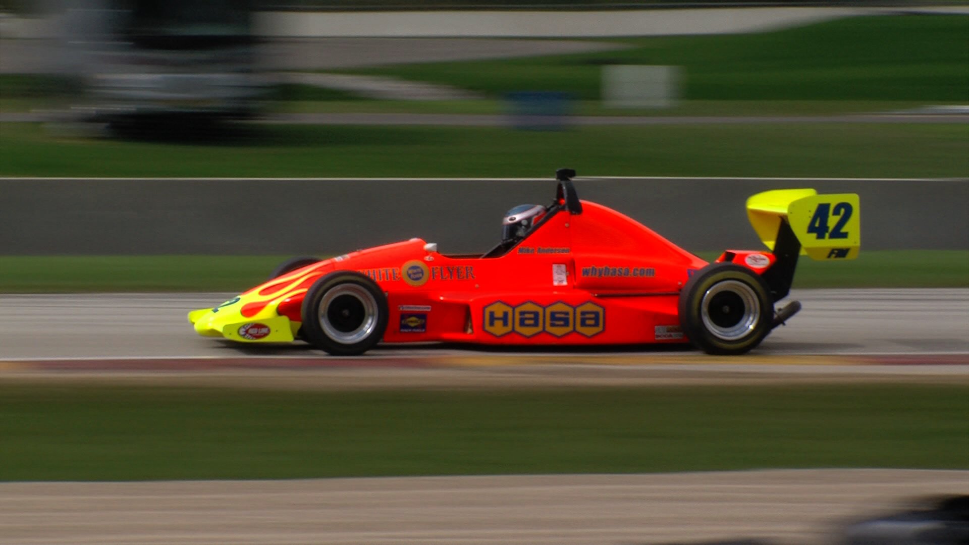 Side profile of Mike Anderson's orange number 42 Formula Mazda at speed
