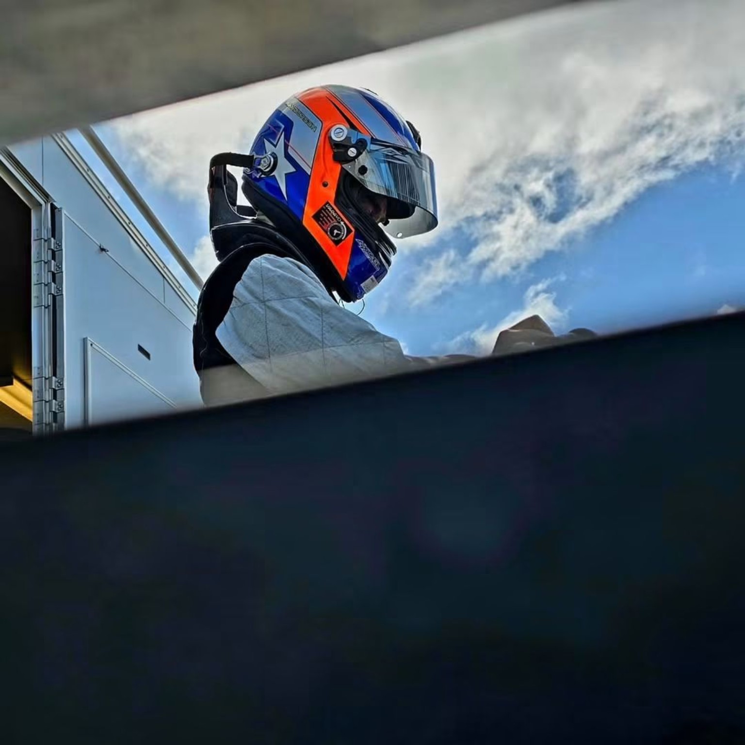 Mike Anderson wearing his racing helmet in the paddock