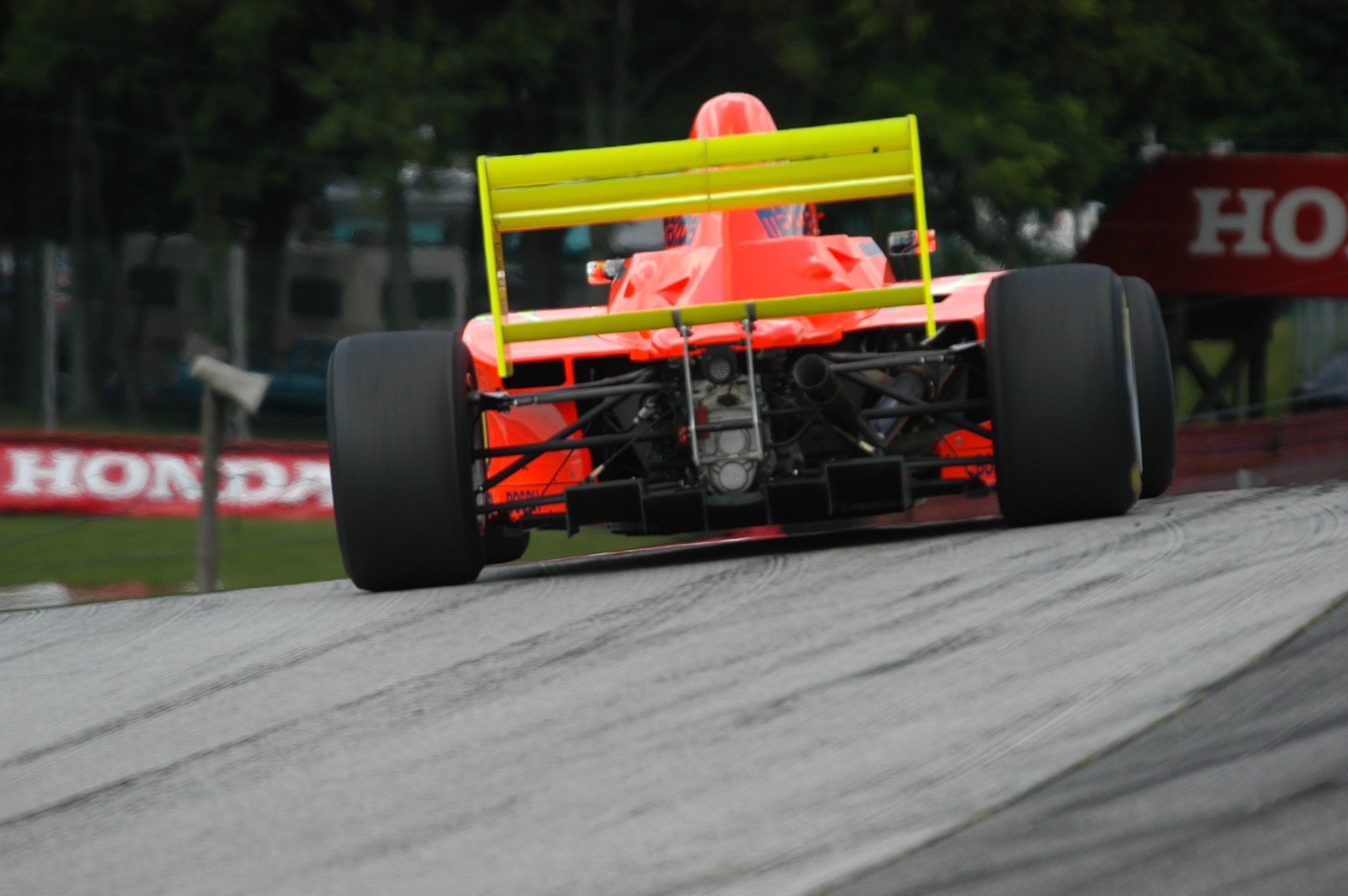 Rear view of Mike Anderson's orange and yellow Pro Formula Mazda at Mid-Ohio