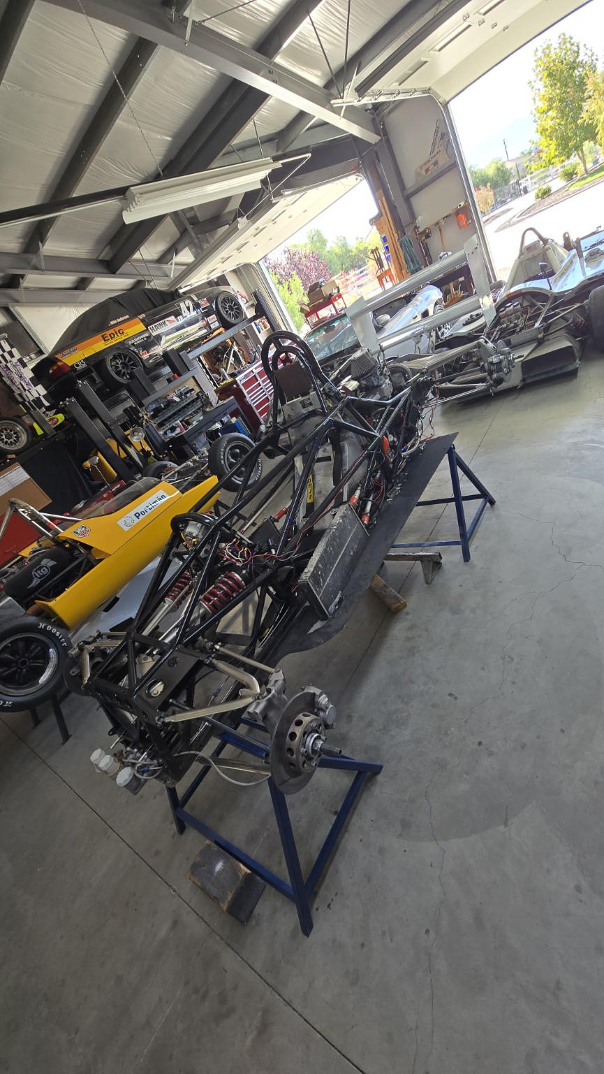 A formula race car stripped to its chassis for extensive preparation in the workshop
