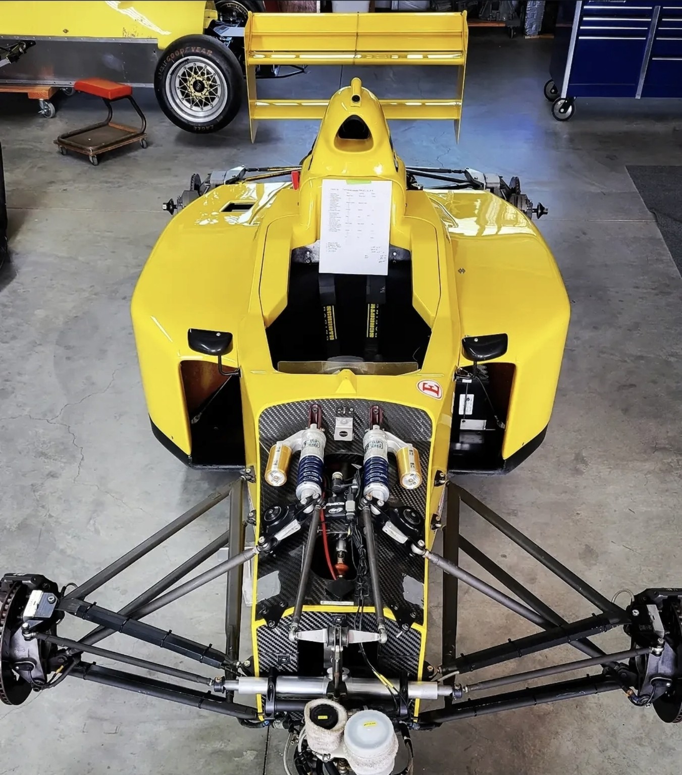 A formula race car undergoing preparation in the Mike Anderson Racing shop