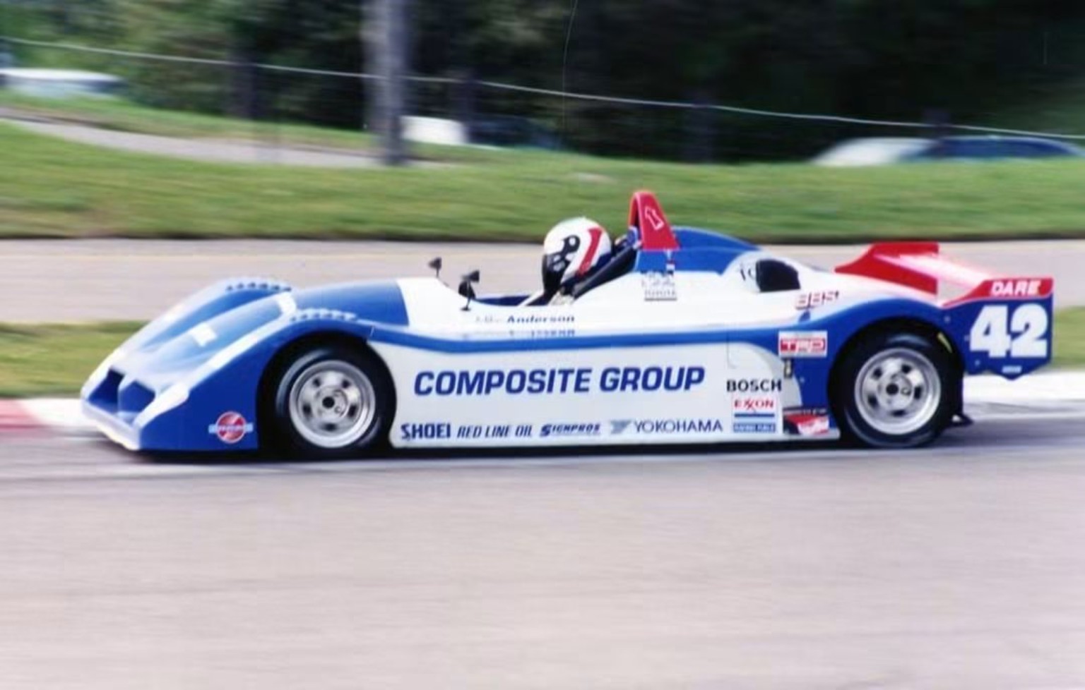Mike Anderson driving the blue, white, and red number 42 Sports Toyota at speed