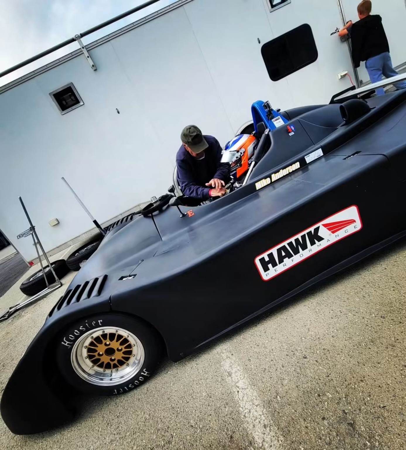 Mike Anderson preparing in the cockpit of his restored black Sports Toyota