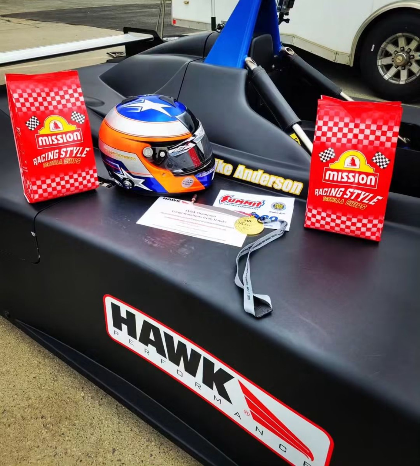 Mike Anderson's helmet, recognition certificate, and restored black Sports Toyota number 42